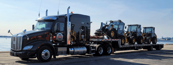 Step-deck semi parked in harbor