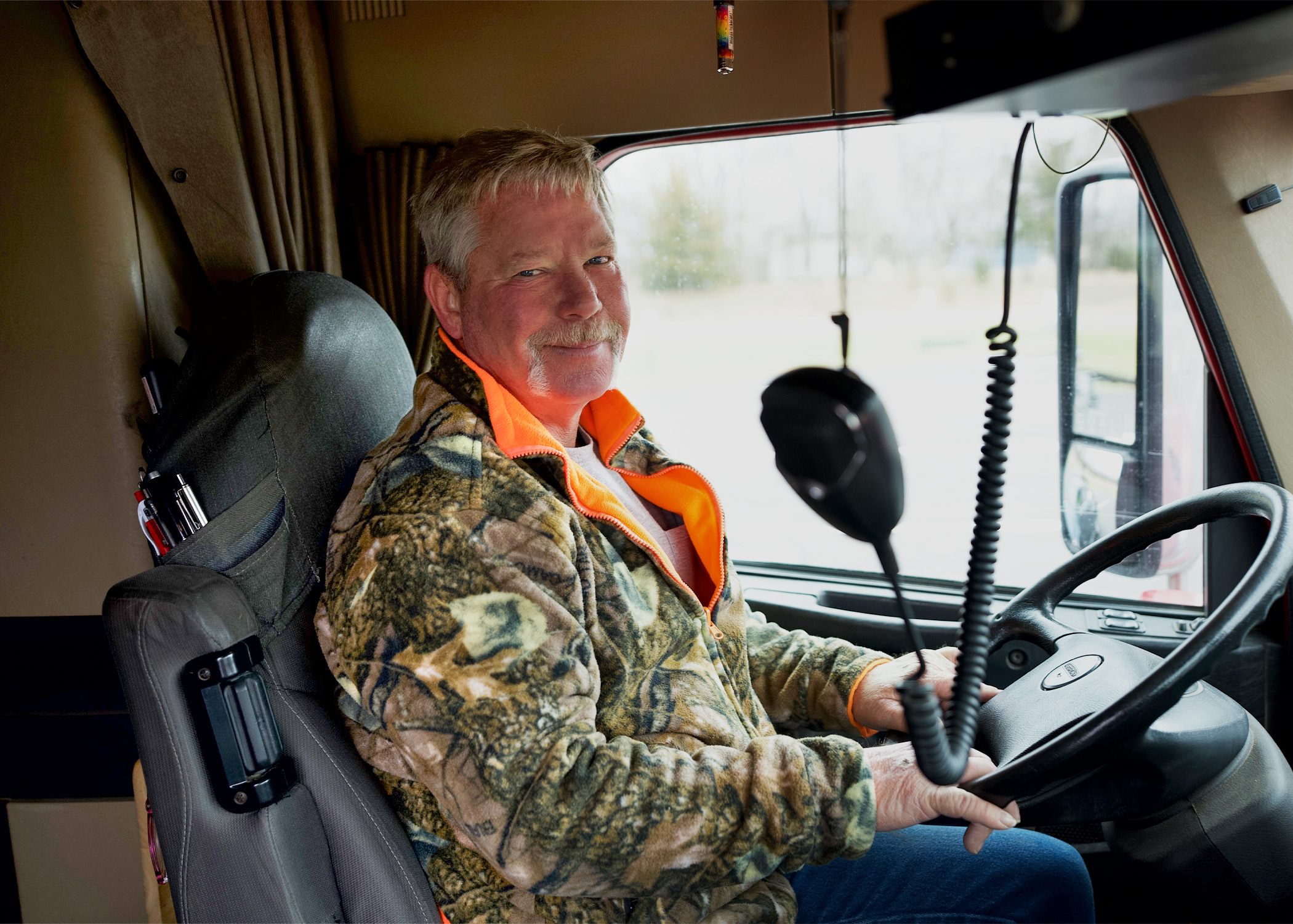 Independent Contractor Driver Sitting in Cab of Truck
